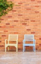 Red brick wall with chairs