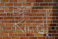 Red brick wall chalk inscription Be Kind and flag of the USA