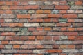 Red brick wall with colorful colored bricks, red, green, gray, brown in summer in Bruges, Belgium, red wall texture, as background Royalty Free Stock Photo