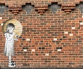 Red brick wall with graffitti of a small girl holding a flower Royalty Free Stock Photo