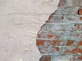 red brick wall and half ruined white stucco Royalty Free Stock Photo