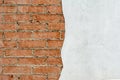 Red brick wall and half-ruined white stucco, architecture abstract background Royalty Free Stock Photo