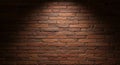 Red brick wall illuminated by a soft spotlight from above. The bricks have a slightly Royalty Free Stock Photo