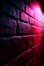 A red brick wall with a light shining through it Royalty Free Stock Photo