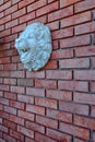 Red Brick wall with the Lion Face Sculpture Royalty Free Stock Photo