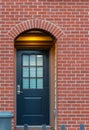 Red brick wall with nice brown door. Exteriror of a house. Entrance of a nice single family house