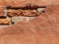 Red brick wall of an old building with crumbling plaster. Copy space. Royalty Free Stock Photo