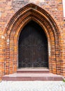 A red brick wall and old doors. Background of an old brick wall with a wooden door. Royalty Free Stock Photo