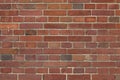 Red brick wall with pointing rom far away.