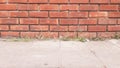 Red brick wall scene on concrete floor Royalty Free Stock Photo