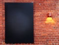 Red brick wall with black board hanging on it Royalty Free Stock Photo