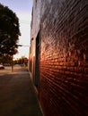 Red brick wall seen in perspective with sunlight reflecting