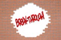 Red brick wall with the text BREAKTHROUGH! Royalty Free Stock Photo