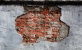 Red brick wall texture in the center under peeling plaster, modern style background, architecture detail Royalty Free Stock Photo