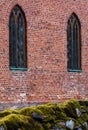 Red brick wall with two vertical windows Royalty Free Stock Photo