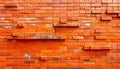 Red Brick Wall with Geometric Protruding Bricks and Shadow Play textured Royalty Free Stock Photo