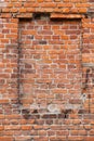 Red brick wall with a window that is blocked by bricks, an old house close-up Royalty Free Stock Photo
