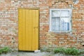 Red brick wall, wooden door and window Royalty Free Stock Photo