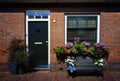 Red bricks house facade with window, door, bench and flowers Naarden Netherland Royalty Free Stock Photo