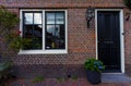 Red bricks house facade with window door and flowers Naarden Netherland Royalty Free Stock Photo