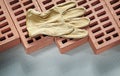 Red bricks leather working gloves on concrete surface constructi Royalty Free Stock Photo