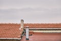 Red bricks roof, metal and concrete made of chimney