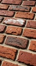 Red bricks with a rough, textured surface arranged in a staggered pattern. Slight Royalty Free Stock Photo