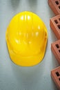 Red bricks safety cap on concrete surface top view construction Royalty Free Stock Photo