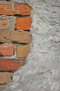 Red bricks stone wall background closeup, cracked ruined stucco