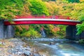 A red bridge across river in autumn, Japan Royalty Free Stock Photo