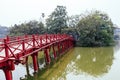 Red Bridge at Hoan Kiem Lake with tress and reflected shadow in Hanoi, Vietnam