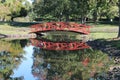 Red Bridge over Peaceful Stream