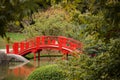 Red bridge over a pond in a beautiful Japanese Garden Royalty Free Stock Photo