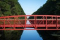 Red bridge over tree-lined canal