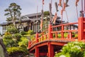 A red bridge over water in a Japanese garden Royalty Free Stock Photo