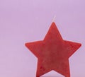 Red candle star on purple background Royalty Free Stock Photo