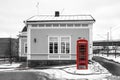 Red British phone box standing by the traditional wooden cottage Royalty Free Stock Photo