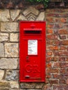 A red British post box in a wall Royalty Free Stock Photo