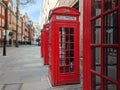 Red British Telephone Boxes along Traditional English Setting in London
