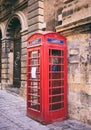 Red British vintage telephone booth in Valletta, Malta Royalty Free Stock Photo