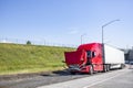 Red broken big rig semi truck with open hood standing on the road shoulder out of service Royalty Free Stock Photo