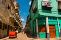 Red broken car. Street scene with classic old cars and traditional colorful buildings in downtown Havana. Cuba Royalty Free Stock Photo