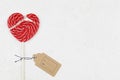 Red broken heart as lollipop candy. Valentines day minimalist background. love symbol, space for text concept Royalty Free Stock Photo