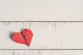 Red broken heart on white wooden background Royalty Free Stock Photo