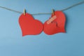 Red broken heart and whole heart hanging on rope Royalty Free Stock Photo