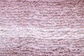 Red brown fabric texture. Close-up of a pink fluffy soft bath mat or rug or textile background. Macro photograph. Beautiful bright Royalty Free Stock Photo