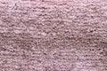 Red brown fabric texture. Close-up of a pink fluffy soft bath mat or rug or textile background. Macro photograph. Beautiful bright Royalty Free Stock Photo