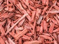 Red and brown pieces of tree wood texture background. Mulch ground Royalty Free Stock Photo