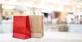 Red and brown shopping bags in mall store background