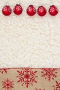 Red and brown snowflake border with ornaments winter background on beige sherpa material